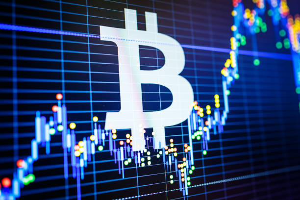 istock Data analyzing in exchange stock market: the candle chars on display. Analytics price change cryptocurrency BTC to USD (Bitcoin / US Dollar), the most popular pair in the world. Big Bitcoin logo. 880534666