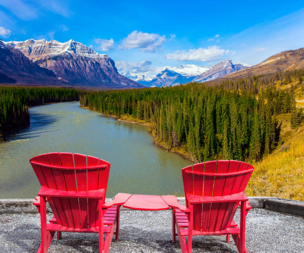 istock Two red loungers by the Abraham lake 880541500