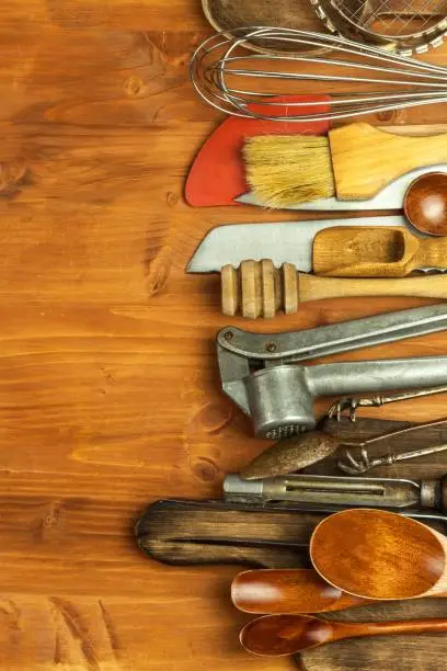 Old kitchen utensils on a wooden board. Sale of kitchen equipment. Chef's tools