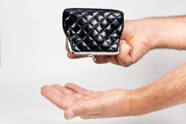 istock Man holding an empty wallet over an empty hand . The concept of poverty 880549456