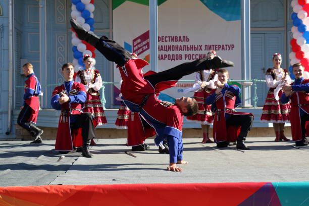 The Cossack dance in traditional clothes. Pyatigorsk, Russia Pyatigorsk, Russia - November 4, 2017: Cossack dance in traditional clothes. Free concert near the Lermontov Gallery in Tsvetnik park in Pyatigorsk. Celebration of National Unity Day in Russia. cossack stock pictures, royalty-free photos & images