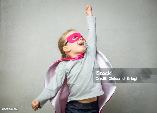 Little Girl Pretending That She Is Flying Wearing A Cloak And Mask Stock Photo - Download Image Now