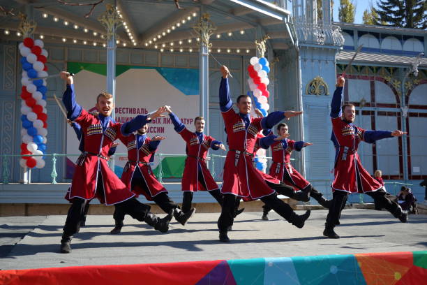 The Cossack dance with sabers. Russia Pyatigorsk, Russia - November 4, 2017: The Cossack dance in traditional clothes. Group of dancers with sabers. Celebration of National Unity Day in Russia. Free concert cossack stock pictures, royalty-free photos & images