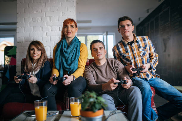 istock Colleagues playing video games in the office relax room 880562478