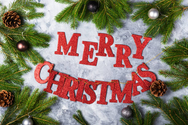istock Xmas Tree Branches, Baubles, and Red Letters Merry Christmas 880571016