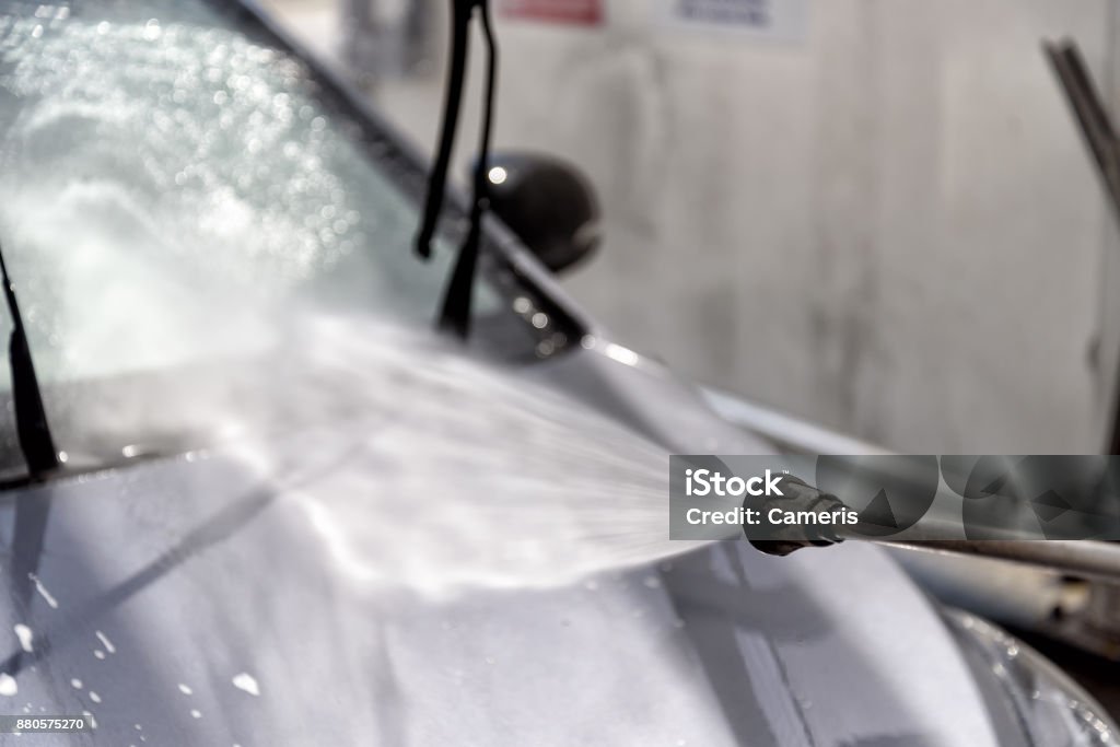 car wash cleaning a car at the car wash Brushing Stock Photo