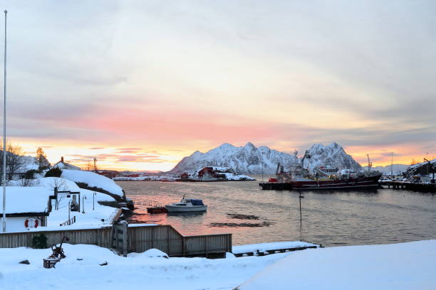 SE.-wards view-sunrise over Svolvaer fishing port-Litlmolla island in background. Lofoten-Nordland-Norway.0601 SE.-wards view from Lofoten Rorbuer suites in the NE.area of town-sunrise over Svolvaer fishing port-big maroon fishing ship moored at the dock-Litlmolla island in background. Lofoten-Nordland-Norway. harbor of svolvaer in winter lofoten islands norway stock pictures, royalty-free photos & images