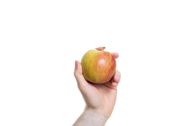 istock Holding an apple in the hand isolated on white background 880596234