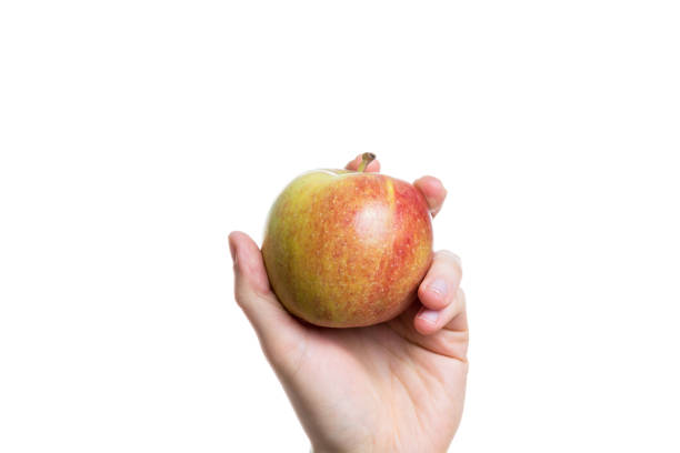 istock Holding an apple in the hand isolated on white background close up 880596238