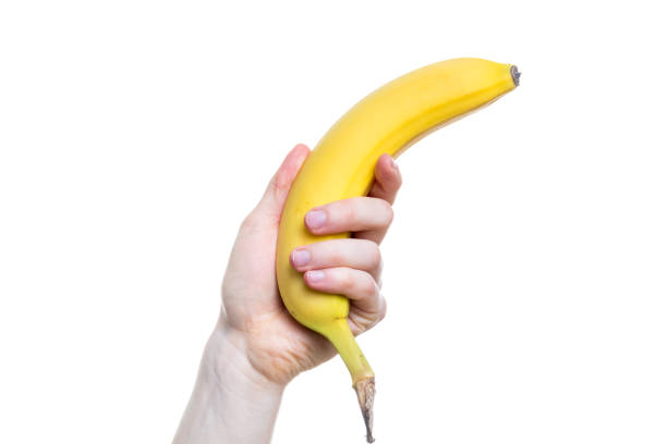 istock Holding a banana in the hand isolated on white background 880596418