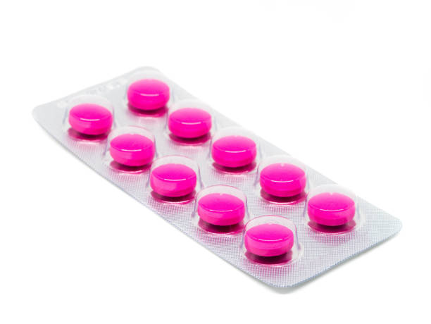 istock pink tablets pills in blister pack isolated on white background. 880598874