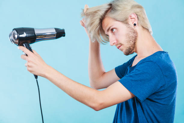 istock Trendy man with hair dryer 880605800