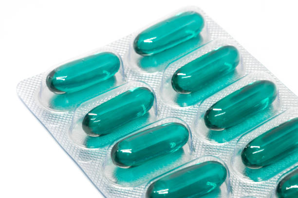 istock green soft gel capsules pills in blister pack isolated on white background. 880610488