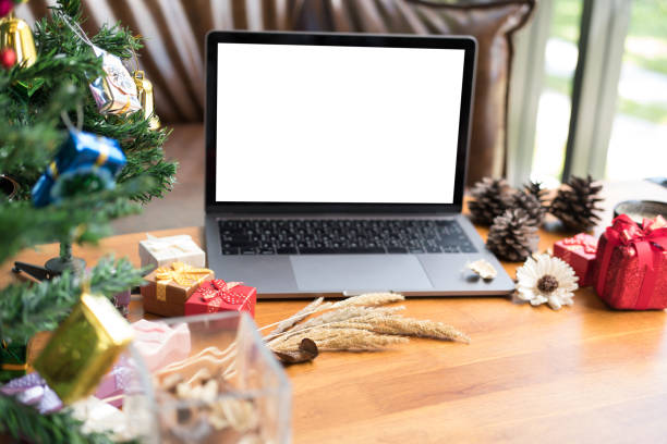 istock computer, xmas gift box, coffee cup on wood table. christmas and new year holiday celebration. 880620116