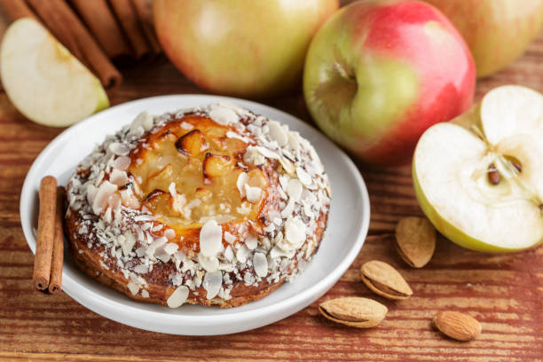 istock Homemade Apple pie with almonds and cinnamon. Dessert for tea in a rustic style. Selective focus 880620374