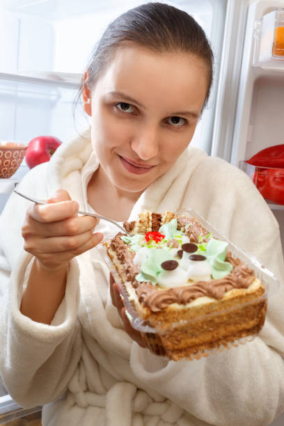 istock hungry woman eating 880627346