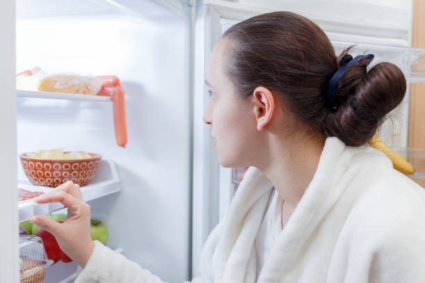 istock woman near refrigerator 880627368