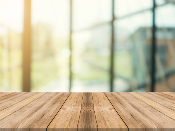 istock Wooden board empty table top on of blurred background. Perspective brown wood table over blur in coffee shop background - can be used mock up for montage products display or design key visual layout. 880632814