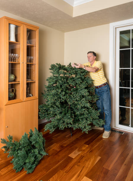 istock Senior man putting artificial christmas tree together for XMAS 880645234