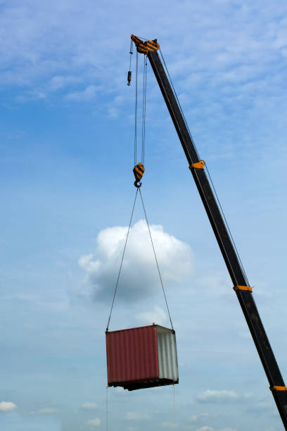 istock Crane lifting cutoff container moving in to the sky. 880706094