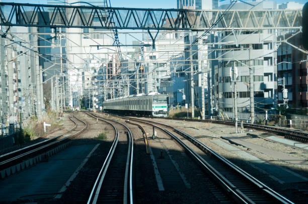 istock Complex railway tracks with upcoming train in Tokyo Japan 880715792