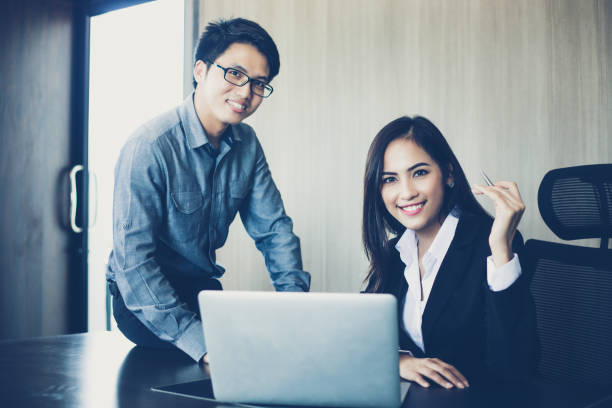 istock Asian businessmen and group using notebook for business partners discussing documents and ideas at meeting and business women smiling happy for working 880718104