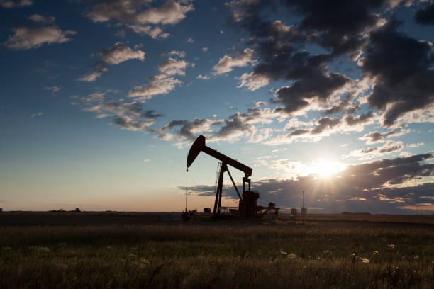 Prairie Oil Saskatchewan Canada Pump Jacks working out in Weyburn Saskatchewan, Canada. Image taken from a tripod. oil pump petroleum equipment development stock pictures, royalty-free photos & images