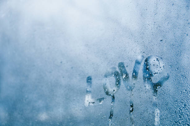 istock Love text draw on droplet window of cold misty morning 880732674