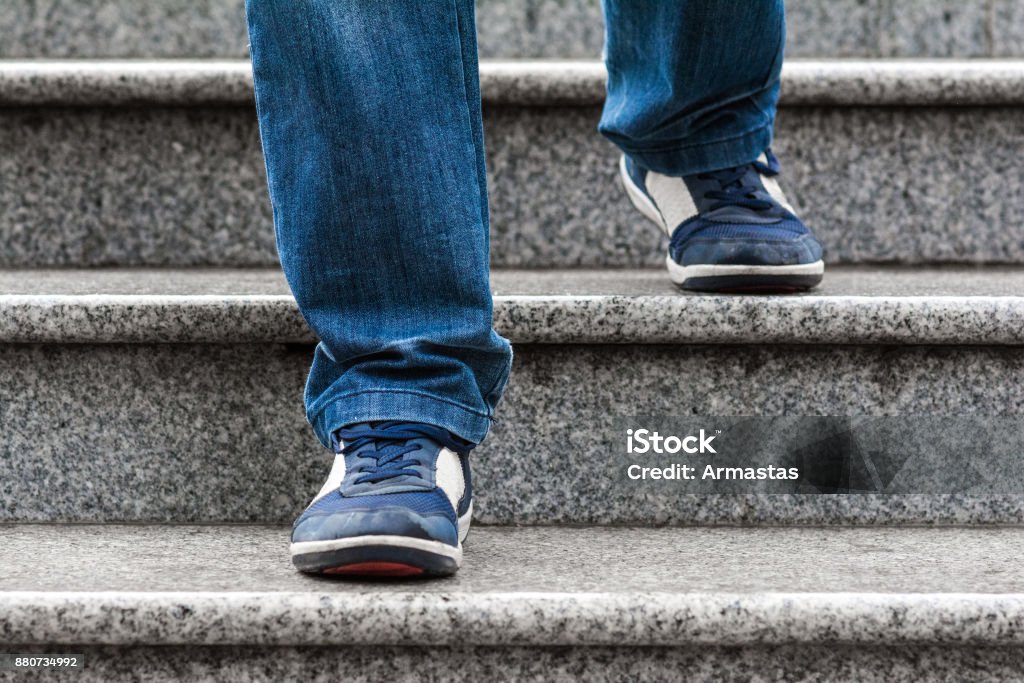 A man goes down the stairs Staircase Stock Photo