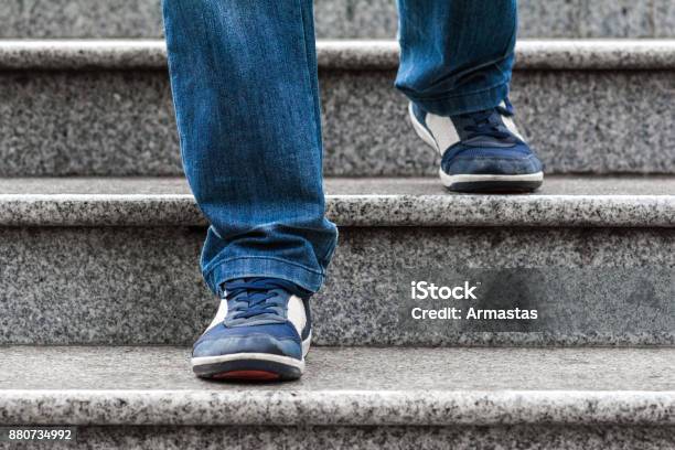 A Man Goes Down The Stairs Stock Photo - Download Image Now - Staircase, Steps, Moving Down