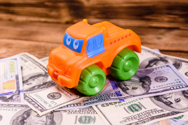 istock Toy car on a one hundred dollar bills 880742956