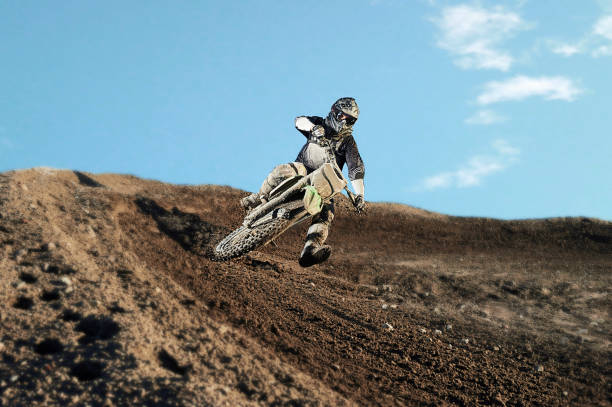 istock Motocross rider on race track 880745434