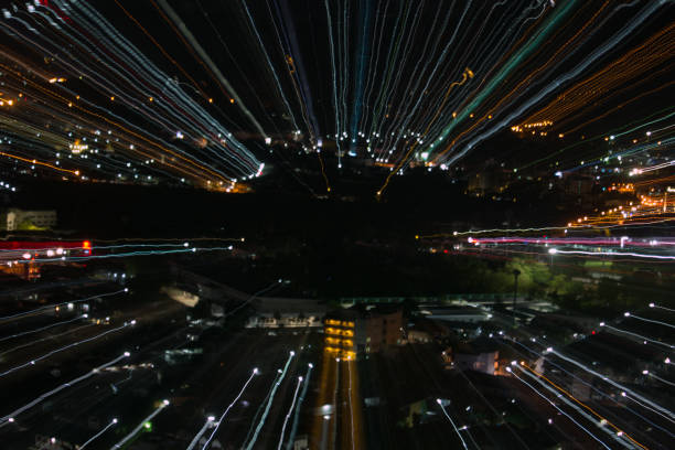 istock light lines with long exposure,  speed motion abstract background in the dark night ,  blast zoom effect , zoom burst of light in the city 880748354