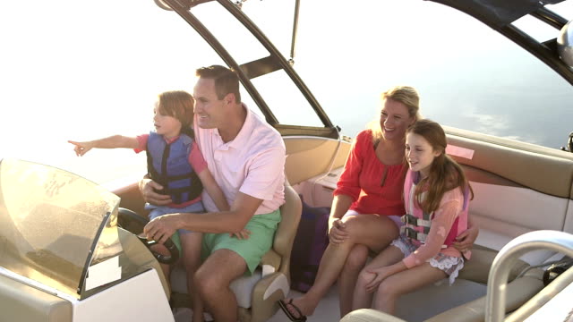 Family with two children taking a boat ride