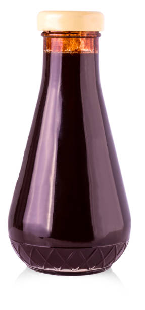 istock glass bottle with dark sauce on a white background. 880753166