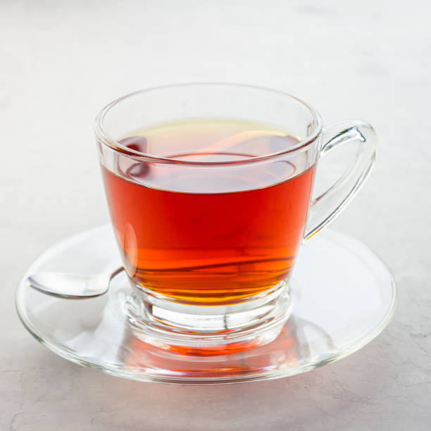 istock Healthy herbal rooibos red tea in glass cup, square 880755516