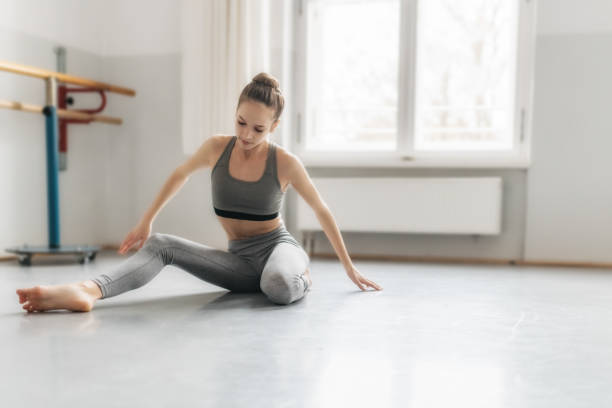istock girl doing gymnastics on floor in studio 880761060