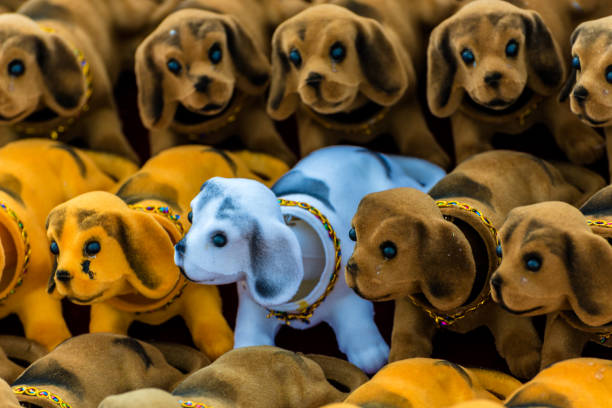 Many plastic dog toys together with different colors are on stall for sale
