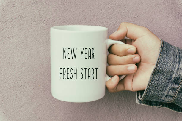 Hands Holding a Coffee Mug With Text New Year Fresh Start New Year Concept Retro Style new years day photos stock pictures, royalty-free photos & images