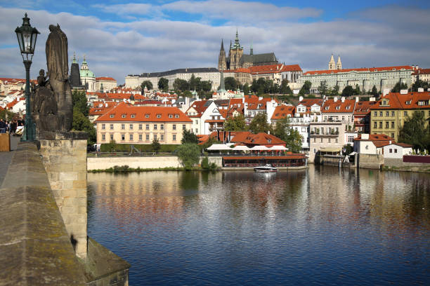 istock Panoramic view on St. Vitus Cathedral from Charles Bridge with statues on the Bridge Karluv Most in Prague, Czech Republic 880771242