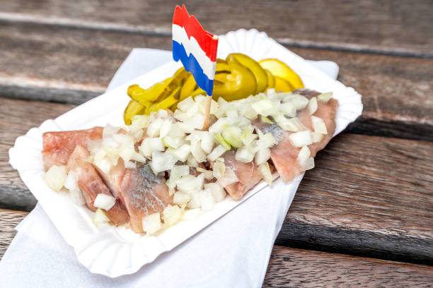 istock traditional Dutch snack with raw herring with pickles 880776232