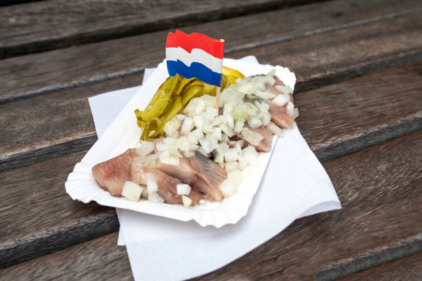 istock traditional Dutch snack with raw herring with pickles 880776286