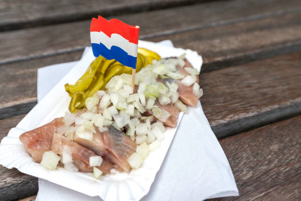 istock traditional Dutch snack with raw herring with pickles 880776310