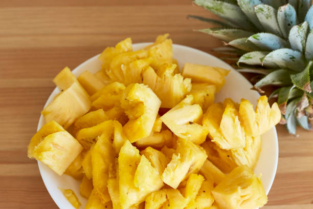 istock Sliced Pineapple White Plate on Wooden 880815200