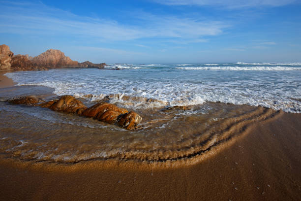 istock Scenic sandy beach with waves and blue sky 880815462