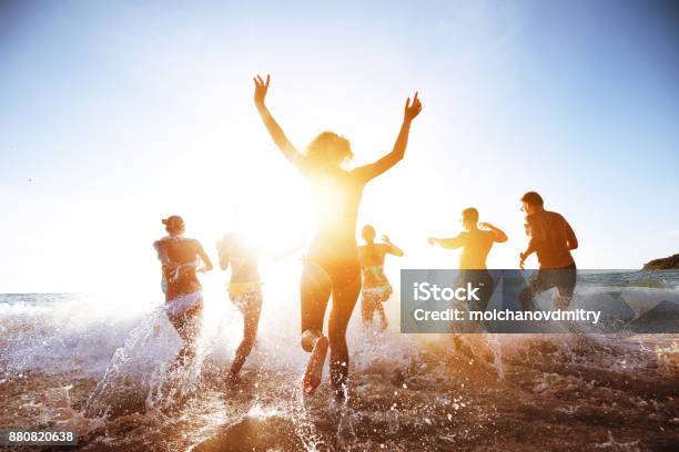 Beautiful People Sunset Sea Beach Stock Photo - Download Image Now - Beach, Beach Party, Running