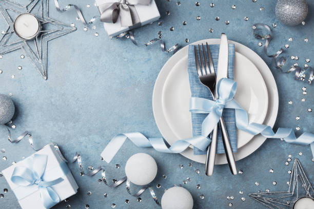 istock Table setting with gift boxes and holiday decorations top view. Preparation for christmas dinner. 880826108