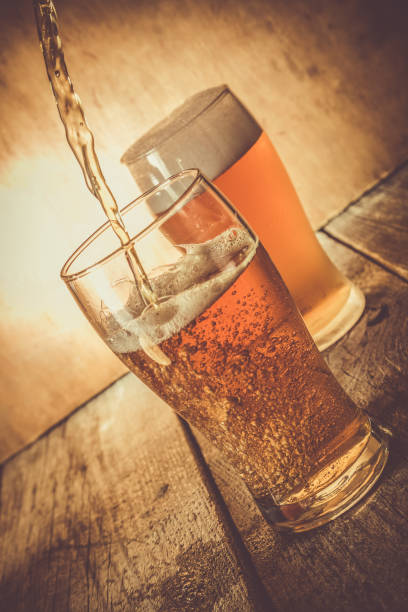istock Beer in frosty mugs on rustic background 880839252