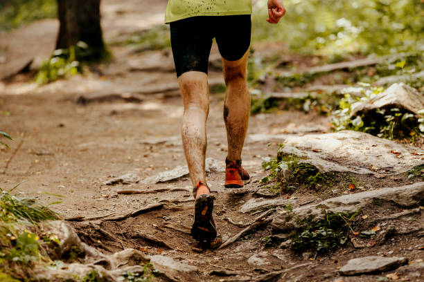istock athlete runner dirty feet running forest trail 880842212