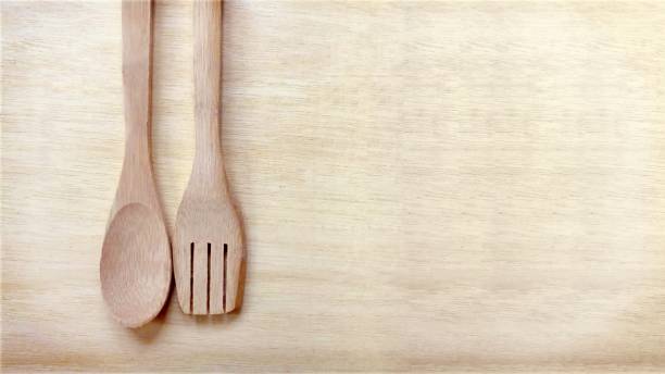 istock Wooden Spoon and Fork on Wooden Plank Background 880844954